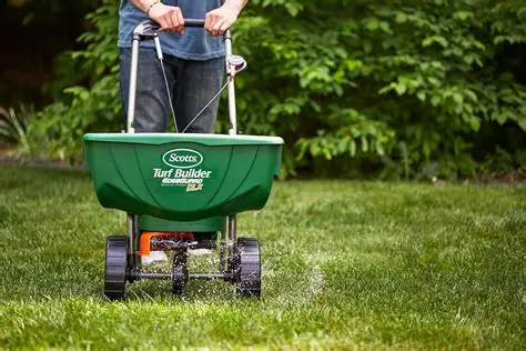 Scotts Turf Builder EdgeGuard Mini Spreader in a green lawn