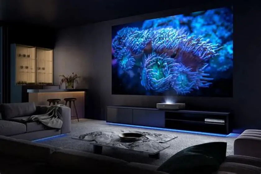 Modern short throw projector 4K displaying a large, vibrant movie scene on a living room wall